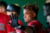 FILE - In this Feb. 24, 2020, file photo, Arizona Diamondbacks' Domingo Leyba waves to teammates after hitting a three-run home run against the San Francisco Giants during the fourth inning of a spring training baseball game in Scottsdale, Ariz. Leyba was suspended for 80 games on Friday, March 6, 2020, following a positive test under Major League Baseball's drug program. (AP Photo/Ross D. Franklin, File)