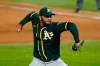 FIE - In this Aug. 24, 2020, file photo, Oakland Athletics relief pitcher Yusmeiro Petit throws to the Texas Rangers in the seventh inning of a baseball game in Arlington, Texas. Veteran reliever Petit has agreed to a $2.55 million, one-year contract to stay with the Athletics, pending a physical, his agent said. The deal could pay the right-handed Petit up to $3 million based on incentives for games pitched, agent Rafael Godoy said Sunday, Feb. 14, 2021. (AP Photo/Tony Gutierrez, File)