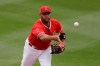 FILE - In this Feb. 28, 2020, file photo, Los Angeles Angels first baseman Albert Pujols throws the ball during the fourth inning of a spring training baseball game against the Texas Rangers in Tempe, Ariz. Pujols will pay the salaries of the Angels' furloughed employees in his native Dominican Republic for five months, a person with knowledge of the decision told The Associated Press. The person spoke on condition of anonymity Friday, June 19, 2020, because Pujols did not publicly announce his commitment to pay roughly $180,000 to cover the salaries. (AP Photo/Charlie Riedel, File)