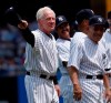 FILE - In this July 7, 2007 file photo, former New York Yankees pitcher, Whitey Ford, left, acknowledges the crowd during introductions as Yogi Berra, right looks on before the Old Timer's game at Yankee Stadium in New York. A family member tells The Associated Press on Friday, Oct. 9, 2020 that Ford died at his Long Island home Thursday night. (AP Photo/Julie Jacobson, File)