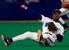 FILE - In this Sept. 17, 1999, file photo, Toronto Blue Jays third baseman Tony Fernandez throws to first as he tumbles to the turf during third-inning AL action against the Chicago White Sox in Toronto. Former All-Star shortstop Fernandez remained on a life support system Sunday, Feb. 16, 2020, pending a decision by his family on how to proceed, the director of his foundation said. He had been in a medically induced coma, said Imrad Hallim, the director and co-founder of the Tony Fernández Foundation. Fernandez was ill with a kidney disease for years and waiting for a transplant. (Frank Gunn/The Canadian Press via AP, File)