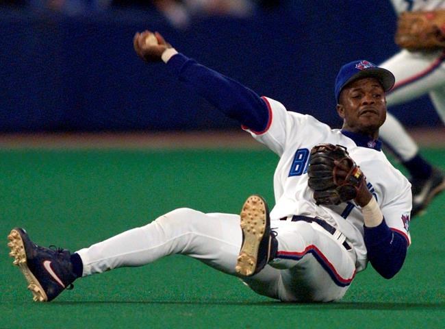 FILE - In this Sept. 17, 1999, file photo, Toronto Blue Jays third baseman Tony Fernandez throws to first as he tumbles to the turf during third-inning AL action against the Chicago White Sox in Toronto. Former All-Star shortstop Fernandez remained on a life support system Sunday, Feb. 16, 2020, pending a decision by his family on how to proceed, the director of his foundation said. He had been in a medically induced coma, said Imrad Hallim, the director and co-founder of the Tony Fernández Foundation. Fernandez was ill with a kidney disease for years and waiting for a transplant. (Frank Gunn/The Canadian Press via AP, File)