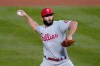 FILE - In this Sept. 4, 2020, file photo, Philadelphia Phillies starting pitcher Jake Arrieta throws in the first inning of a baseball game against the New York Mets in New York. Arrieta is returning to the Chicago Cubs, agreeing to a $6 million, one-year contract on Friday, Feb. 12, 2021. Arrieta can earn $1 million in performance bonuses, according to a person familiar with the situation who confirmed the deal on condition of anonymity because it is pending a physical. (AP Photo/John Minchillo, File)