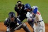 FILE - In this Oct. 27, 2020, file photo, Los Angeles Dodgers' Mookie Betts, right, hits a home run against the Tampa Bay Rays during the eighth inning in Game 6 of the baseball World Series in Arlington, Texas. New York Mets ace Jacob deGrom is going for his third consecutive NL Cy Young Award, and Dodgers' Mookie Betts could become the second player to win the MVP award in each league. (AP Photo/Sue Ogrocki, File)