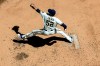 FILE - In this July 13, 2020, file photo, Milwaukee Brewers' Justin Grimm throws during a baseball practice session at Miller Park in Milwaukee. Brewers reliever Grimm and outfielder-first baseman Logan Morrison learned they made the team after reporting to camp as non-roster invitees. The news was particularly sweet for Grimm, who made at least 50 appearances for the Chicago Cubs every season from 2014-17 but has bounced around a few organizations since and spent all of last season in the minors. (AP Photo/Morry Gash, File)
