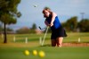 In this Aug. 28, 2019, file photo, Amy Bockerstette practices with her teaching pro at Palmbrook Country Club in Sun City, Ariz. Bockerstette is set to become the first person with Down syndrome to compete in a national collegiate athletic championship. (AP Photo/Ross D. Franklin, File)