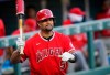 FILE - In this Sept. 12, 2020, file photo, Los Angeles Angels designated hitter Albert Pujols waves to players in the Colorado Rockies dugout in the second inning of a baseball game in Denver. Pujols’ wife apparently disclosed that the Angels slugger will retire after the upcoming season, although she later amended her social media post to be less definitive. (AP Photo/David Zalubowski, File)