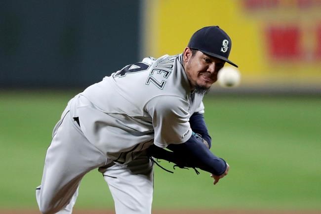FILE - In this Sept. 20, 2019, file photo, Seattle Mariners starting pitcher Felix Hernandez throws to a Baltimore Orioles batter during the second inning of a baseball game in Baltimore. Longtime Mariners ace Hernandez reached a minor league deal with the Atlanta Braves on Monday, Jan. 20, 2020, that includes an invite to big league spring training. (AP Photo/Julio Cortez, File)