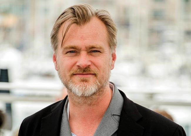 FILE - In this May 12, 2018, file photo, director Christopher Nolan poses during a photo call at the 71st international film festival in Cannes, southern France. Warner Bros. says it will release Nolan's latest film, the sci-fi espionage spectacle “Tenet,
