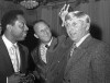 FILE In this Jan. 25, 1971, file photo, Stan Musial, center, vice president of the St. Louis Cardinals, jokes around as he reaches to feel a blond wig worn by Joe Cunningham, right, manager of the Cardinals, as Atlanta Braves' Hank Aaron, left, watches in St. Petersburg, Fla. Cunningham, who got off to a smashing start with the Cardinals and later became a minor league manager, major league coach, key figure in their front office and team ambassador, has died. He was 89. (AP Photo/Fred Waters, File)