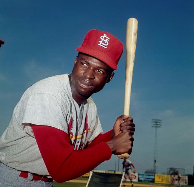 FILE - In this April 9, 1965, file photo, Lou Brock, of the St. Louis Cardinals, poses in Missouri. Hall of Famer Brock, one of baseball’s signature leadoff hitters and base stealers who helped the Cardinals win three pennants and two World Series titles in the 1960s, has died. He was 81. (AP Photo, File)