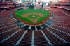 FILE - In this July 24, 2020, file photo, empty seats are viewed in Busch Stadium as St. Louis Cardinals starting pitcher Jack Flaherty throws in the first inning baseball game against the Pittsburgh Pirates in St. Louis. Major League Baseball players rejected a proposal to delay the start of spring training and the season due to the coronavirus pandemic, vowing Monday, Feb. 1, 2021, to report under the original schedule. (AP Photo/Jeff Roberson, File)