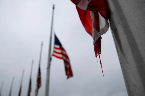 FILE - In this May 22, 2020, file photo, a raindrop falls from an American flag at half-staff at the Washington Monument, in Washington. President Donald Trump ordered American flags to be flown at half-staff for a three day period in remembrance of Americans who have lost their lives due to the coronavirus outbreak. (AP Photo/Patrick Semansky, File)