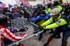 Trump supporters try to break through a police barrier, Wednesday, Jan. 6, 2021, at the Capitol in Washington. (AP Photo/John Minchillo)