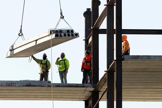 FILE - In this Dec. 3, 2019, file photo, workers erect a building under construction in Philadelphia. Spending on U.S. construction projects edged down a slight 0.2% in December 2019, closing out a year when total construction registered its first annual decline in eight years. (AP Photo/Matt Rourke, File)