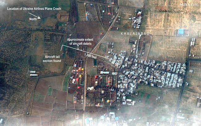This satellite photo provided by Maxar Technologies on Thursday, Jan. 9, 2020, shows the site where a Ukrainian jetliner crashed late Tuesday near the town of Shahedshahr, Iran, southwest of the capital Tehran. The AP has annotated the image to show the location and length of the debris field. A separate version of this image without annotations has also moved. (Satellite image ©2020 Maxar Technologies via AP)
