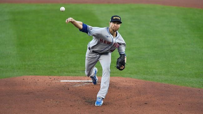 New York Mets starting pitcher Jacob deGrom throws to a Toronto Blue Jays batter during the first inning of a baseball game in Buffalo, N.Y., Friday, Sept. 11, 2020. deGrom is wearing a New York Police Department cap in honor of the 19th anniversary of the Sept. 11, 2001, terror attacks. (AP Photo/Adrian Kraus)