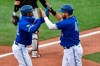 Toronto Blue Jays' Rowdy Tellez, right, and Teoscar Hernández celebrate after both scored against the Baltimore Orioles on a single by Vladimir Guerrero Jr. during the first inning of a baseball game in Buffalo, N.Y., Saturday, Aug. 29, 2020. (AP Photo/Adrian Kraus)