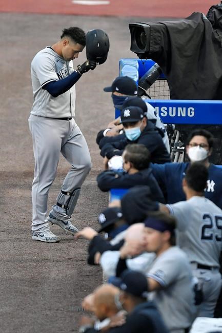 New York Yankees' Gary Sanchez, top, walks back to the dugout after grounding out to Toronto Blue Jays third baseman Joe Panik during the second inning of a baseball game in Buffalo, N.Y., Tuesday, Sept. 8, 2020. (AP Photo/Adrian Kraus)