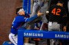 Toronto Blue Jays catcher Danny Jansen, left, gets tangled in the netting while trying to catch a foul ball by the Baltimore Orioles' Pedro Severino during the sixth inning of a baseball game in Buffalo, N.Y., Friday, Aug. 28, 2020. (AP Photo/Adrian Kraus)