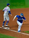 Toronto Blue Jays' Alejandro Kirk, right, takes off from third to score a run on a sacrifice fly by Travis Shaw during the fifth inning of a baseball game in Buffalo, N.Y., Saturday, Sept. 12, 2020. (AP Photo/Adrian Kraus)