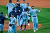 Toronto Blue Jays first baseman Rowdy Tellez, right, celebrates a win over the New York Yankees with teammates after a baseball game in Buffalo, N.Y., Monday, Sept. 7, 2020. (AP Photo/Adrian Kraus)