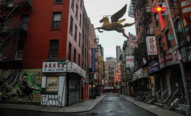 A street in New York's Chinatown is empty, the result of citywide restrictions calling for people to stay indoors and maintain social distancing in an effort to curb the spread of COVID-19, Saturday March 28, 2020, in New York. President Donald Trump says he is considering a quarantine affecting residents of the state and neighboring New Jersey and Connecticut amid the coronavirus outbreak, but New York Gov. Andrew Cuomo said that roping off states would amount to