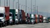 FILE - In this July 22, 2019 photo, trucks hauling shipping containers wait to unload at the Port of Oakland in Oakland, Calif. The Commerce Department issues its second estimate of how the U.S. economy performed in the first quarter of 2020 on Thursday, May 28, 2020.(AP Photo/Ben Margot, File)