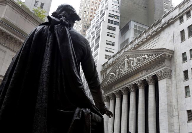 FILE - In this Oct. 2, 2014, file photo, a statue of President George Washington on the steps of Federal Hall faces the facade of the New York Stock Exchange. U.S. stock futures and markets around the world are mostly holding steady or ticking higher early Wednesday, Nov. 4, 2020, but that’s only after they spun through another election night dominated by surprises and sharp swings. (AP Photo/Richard Drew, File)