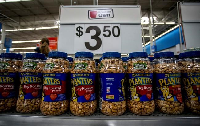 This June 7, 2013 photo shows a display of Planters Peanuts at a Walmart store in Rogers, Ark. Hormel Foods, known for its meat brands like Spam and Applegate, said Thursday, Feb. 11, 2021, it's buying the Planters nut business from Kraft Heinz Co. for $3.35 billion. Included in the deal are Planters brands like Nut-rition, Cheez Balls and Corn Nuts. (AP Photo/Gareth Patterson, File)