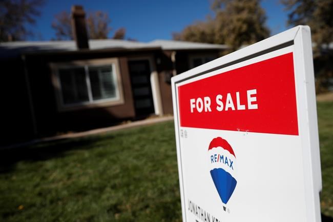 FILE - In this Oct. 22, 2019, file photo, a sign stands outside a home for sale in southeast Denver. On Friday, Feb. 21, 2020, the National Association of Realtors reports on sales of existing homes in January, (AP Photo/David Zalubowski, File)