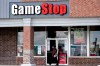 FILE - In this Oct. 15, 2020 file photo, a woman wears a face mask as she walks past a GameStop store in Des Plaines, Ill. Two hedge funds are bowing out of their short positions on the money-losing video game retailer. Citron Research’s Andrew Left said in a video posted on YouTube that his company is going to become more judicious in shorting stocks. Melvin Capital is also exiting GameStop, with manager Gabe Plotkin telling CNBC that the hedge fund was taking a significant loss. (AP Photo/Nam Y. Huh, File)