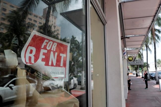 FILE - In this July 13, 2020 file photo, a For Rent sign hangs on a closed shop during the coronavirus pandemic in Miami Beach, Fla. Having endured what was surely a record-shattering slump last quarter, the U.S. economy faces a dim outlook as a resurgent coronavirus intensifies doubts about the likelihood of any sustained recovery the rest of the year. (AP Photo/Lynne Sladky)