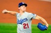 FILE - In this Oct. 23, 2020 file photo, Los Angeles Dodgers starting pitcher Walker Buehler throws against the Tampa Bay Rays during the first inning in Game 3 of the baseball World Series in Arlington, Texas. Buehler and the Los Angeles Dodgers avoided a salary arbitration hearing scheduled for Thursday, Feb. 11, 2021, agreeing to an $8 million, two-year contract that would escalate to more than $12.12 million if he starts regularly this year and wins a Cy Young Award. (AP Photo/Tony Gutierrez, File)