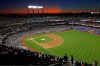 FILE - In this Aug. 29, 2019, file photo, the sun sets behind Citi Field during a baseball game between the New York Mets and the Chicago Cubs in New York. Major League Baseball players ignored claims by clubs that they need to take additional pay cuts, instead proposing they receive a far higher percentage of salaries and a commit to a longer schedule as part of a counteroffer to start the coronavirus-delayed season. (AP Photo/Kathy Willens, File)