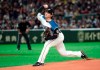 FILE - In this March 17, 2019, file photo, Nippon Ham Fighters starter Kohei Arihara pitches against the Oakland Athletics in the first inning of an exhibition baseball game on Tokyo. Arihara says he settled on the Texas Rangers because they told right-hander what they thought he could do better in addition to mentioning the things they liked. The process of working on some of those things has started with pitchers and catchers officially reporting to spring training in Arizona. (AP Photo/Eugene Hoshiko, File)
