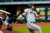 FILE - In this Sept. 18, 2020, file photo, Arizona Diamondbacks' Kole Calhoun follows through on a home run as Houston Astros catcher Martin Maldonado watches during a baseball game in Houston. Calhoun will have surgery Wednesday on his right knee because of a medial meniscus tear. Arizona manager Torey Lovullo said on Tuesday that he wasn’t sure if the injury means Calhoun will miss opening day on April 1. (AP Photo/David J. Phillip, File)