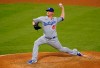 FILE - In this Aug. 15, 2020, file photo, Los Angeles Dodgers reliever Jake McGee throws during the team's baseball game against the Los Angeles Angels in Anaheim, Calif. McGee is guaranteed $5 million in his two-year contract with the San Francisco Giants and could earn $10.5 million over three seasons, including performance bonuses. (AP Photo/Marcio Jose Sanchez, File)