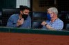 FILE - In this Aug. 12, 2020, file photo, Texas Rangers general manager Jon Daniels, left, talks with Ray Davis, one of the team's owners, during the fourth inning of the Rangers' baseball game against the Seattle Mariners in Arlington, Texas. Davis and the Rangers ownership had hoped for the chance to win the World Series in their first season in their new ballpark. The World Series will be played in the new $1.2 billion stadium, but without the Rangers. Globe Life Field will be a neutral site for two National League playoffs series before the World Series. (AP Photo/Tony Gutierrez, File)