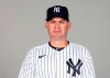 In this Feb. 24, 2021, photo, Carlos Mendoza of the New York Yankees poses for a photo in Florida. Yankees manager Aaron Boone took a leave of absence from the team to get a pacemaker and intends to return to work in a few days. Bench coach Mendoza took over as acting manager for Wednesday night's exhibition against Toronto in Tampa, Fla. The 41-year-old was a minor leaguer mostly with San Francisco and the Yankees from 1997-09 and is starting his 13th season working for the Yankees. (Mike Carlson/MLB Photos via AP, File)