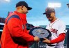 FILE - In this April 11, 2019, file photo, Boston Red Sox manager Alex Cora, left, presents right fielder Mookie Betts with the 2018 AL MVP Award before a baseball game between the Red Sox and the Toronto Blue Jays at Fenway Park in Boston. The award includes the name and image of Kenesaw Mountain Landis. The name of Landis, the former baseball commissioner who never had a Black player in the majors during his long reign, is being pulled off all future MVP plaques after more than 75 years. Landis won't be depicted on the annual awards presented by the Baseball Writers‚Äô Association of the America, the group said Friday, Oct. 2, 2020. (AP Photo/Winslow Townson, File)