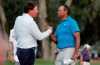 FILE - In this May 10, 2018, file photo, Phil Mickelson, left, and Tiger Woods shake hands after the first round of the Players Championship golf tournament in Ponte Vedra Beach, Fla. Woods and Mickelson are ready for a made-for-TV rematch at a time when fans are craving live action. And this time, they'll have company. Turner Sports says quarterbacks Tom Brady and Peyton Manning will join them for a two-on-two match sometime in May. Missing from the announcement were such details as when and where the match would be played, except that tournament organizers would work with government and health officials to meet safety and health standards. (AP Photo/Lynne Sladky, File)