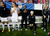 FILE - In this Sept. 18, 2016, file photo, United States' Megan Rapinoe, right, kneels next to teammates Christen Press (12), Ali Krieger (11), Crystal Dunn (16) and Ashlyn Harris (22) as the national anthem is played before the team's exhibition soccer match against the Netherlands in Atlanta. The U.S. women's national team wants the U.S. Soccer Federation to repeal the anthem policy it instituted after Rapinoe started kneeling during the national anthem. The U.S. women's team also wants the federation to state publicly that the policy was wrong and issue an apology to the team's black players and supporters. (AP Photo/John Bazemore, File)