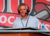 FILE - In this Sept. 25, 2019, file photo, Cincinnati Reds broadcaster Thom Brennaman sits in a special outside booth before the Reds' baseball game against the Milwaukee Brewers in Cincinnati. The Reds say Brennaman has resigned following his use of an anti-gay slur on air in August. (AP Photo/John Minchillo, File)