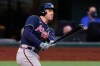 FILE - In this Oct. 13, 2020, file photo, Atlanta Braves' Freddie Freeman watches his two-run home run during the fourth inning in Game 2 of the baseball team's NL Championship Series against the Los Angeles Dodgers in Arlington, Texas. Freeman easily won the NL MVP award Thursday, Nov. 12, topping off a trying year that saw him become so ill with COVID-19 he prayed ‚Äúplease don‚Äôt take me.‚Äù (AP Photo/Eric Gay, File)