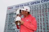 FILE - In this June 16, 2019, file photo, Gary Woodland poses with the trophy after winning the U.S. Open golf tournament in Pebble Beach, Calif. The U.S. Open is returning to NBC starting this year at Winged Foot after Fox Sports has asked to end its 12-year contract with the USGA, multiple people told The Associated Press on Sunday night, June 28, 2020. (AP Photo/Carolyn Kaster, File)