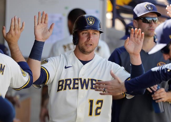 FILE - In this March 1, 2020, file photo, Milwaukee Brewers' Justin Smoak is congratulated after scoring during a spring training baseball game against the Cincinnati Reds in Phoenix. The Yomiuri Giants of Japanese baseball on Thursday, Jan. 7, 2021, announced they have agreed to a deal with Smoak. Smoak played last season with the Milwaukee Brewers and the San Francisco Giants.. (AP Photo/Darron Cummings, File)