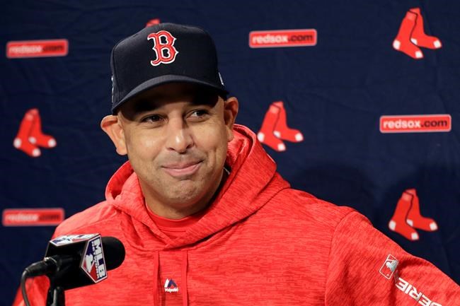 FILE- In this Oct. 21, 2018, file photo, Boston Red Sox manager Alex Cora speaks to media during a baseball work out at Fenway Park in Boston, as they prepare for the World Series against the Los Angeles Dodgers. The Red Sox rehired Cora as manager Friday, Nov. 6, 2020, less than a year after letting him go because of his role in the Houston Astros cheating scandal. (AP Photo/Elise Amendola, FIle)