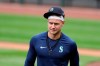 FILE - In this July 3, 2020, file photo, Seattle Mariners outfielder Jarred Kelenic walks on the field during baseball practice in Seattle. Kelenic, a top Seattle prospect, and his agent believe the 21-year-old outfielder has been kept off the Mariners’ major league roster because of his refusal to accept a long-term contract offer from the franchise. (AP Photo/Elaine Thompson, File)