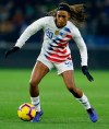 FILE - In this Jan. 19, 2019, file photo, United States forward Jessica McDonald controls the ball during a women's international friendly soccer match againset France at the Oceane stadium in Le Havre, France. There are just a handful of mothers who play professional soccer in the NWSL. But when the league asks players to travel to Utah and be sequestered for more than a month, moms' voices are important. North Carolina Courage forward Jessica McDonald, whose son Jeremiah is 8 years old. She spoke up to new NWSL Commissioner Lisa Baird and got the moms on a call to discuss the tournament. (AP Photo/David Vincent, File)